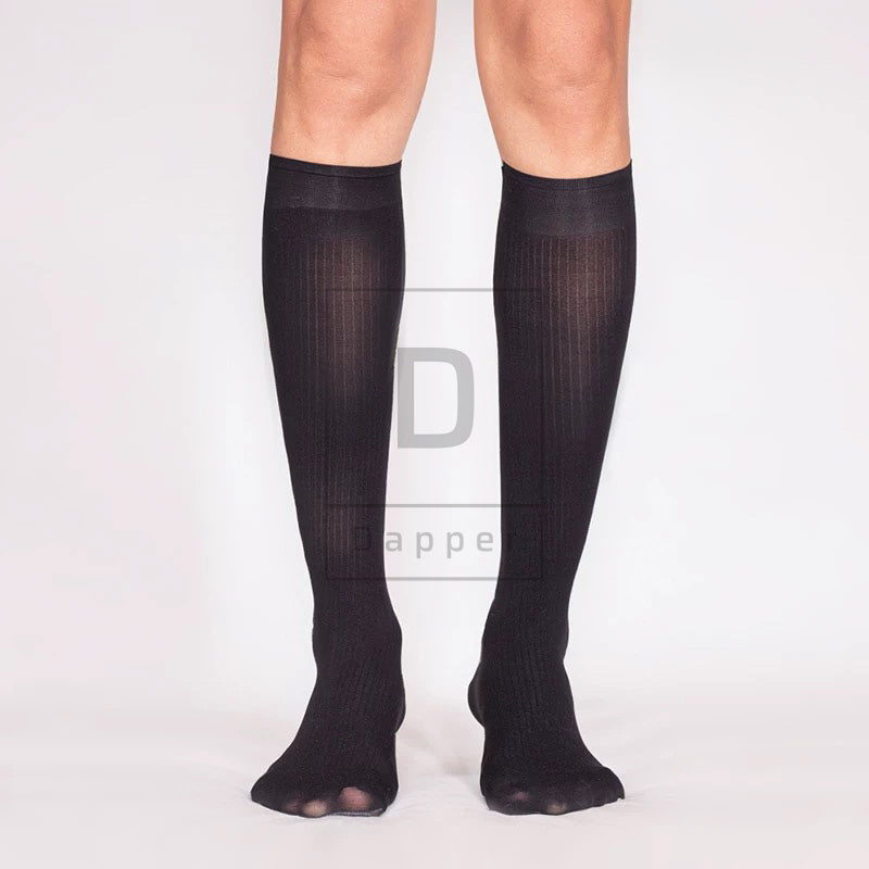 Front view of black Striped Luxe dress socks worn on the legs, showing fine vertical stripes and wide cuffs